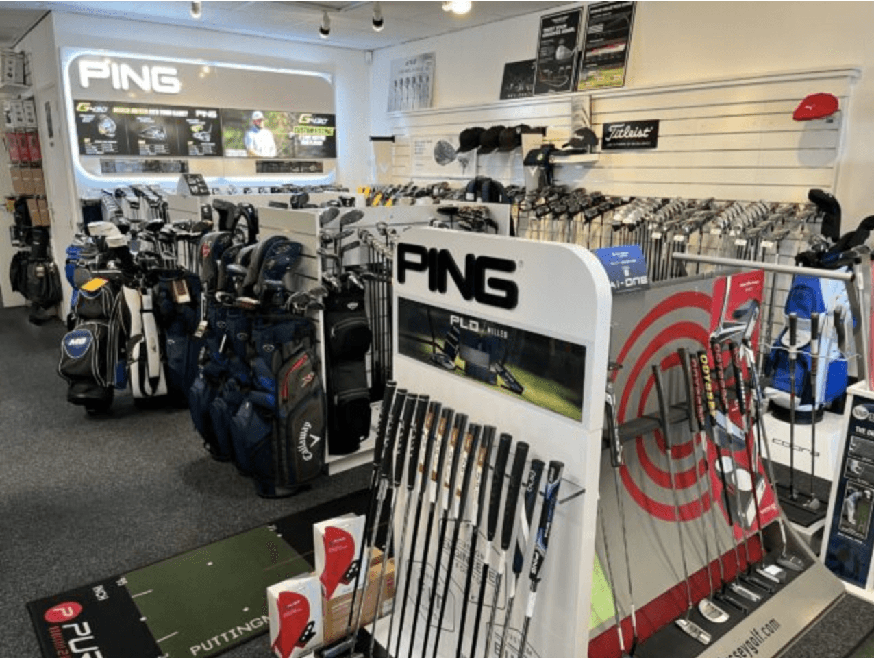 Collectie golfclubs en golfkleding in de winkel